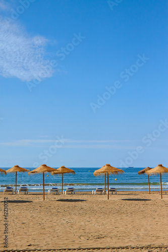 beach featuring levels of white sand  emerald water  dark blue w