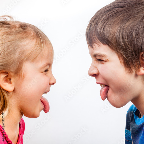 Kids sticking out tongues photo