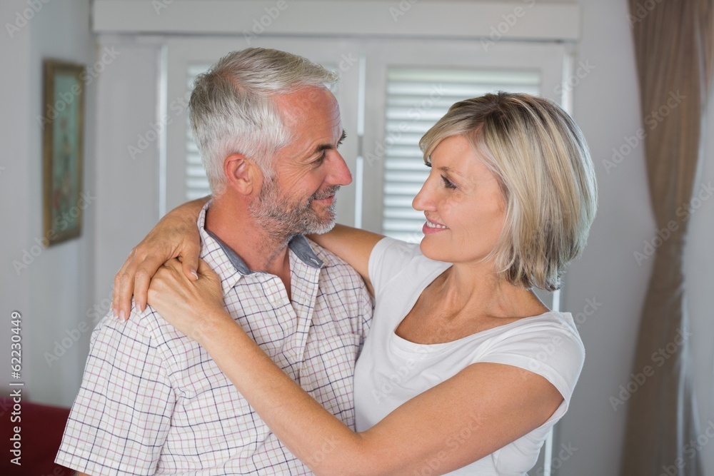 Smiling woman embracing mature man