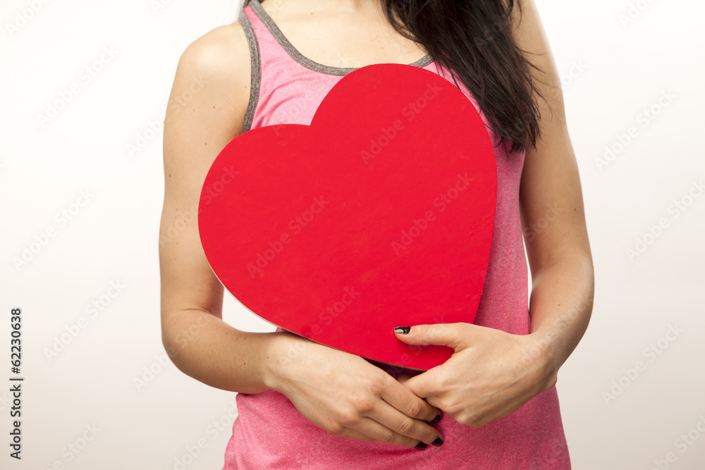 girl holding a heart in her hands girl holding a heart in her hands