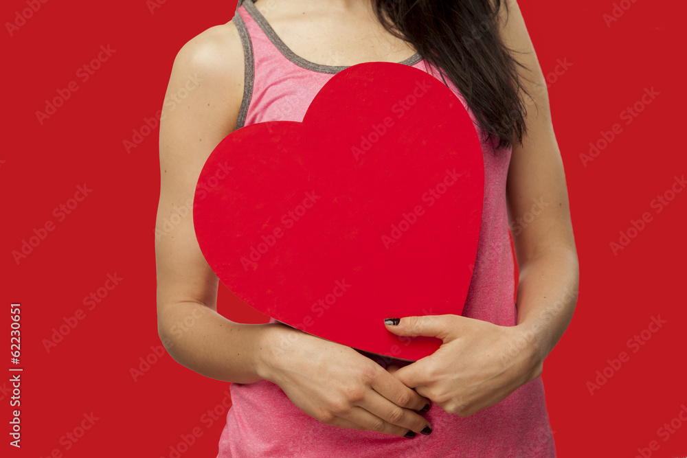 girl holding a heart in her hands girl holding a heart in her hands