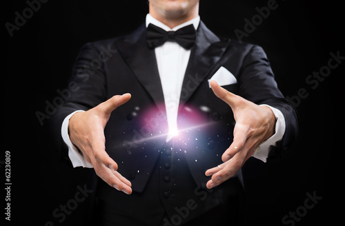 Canvas Print magician in top hat showing trick