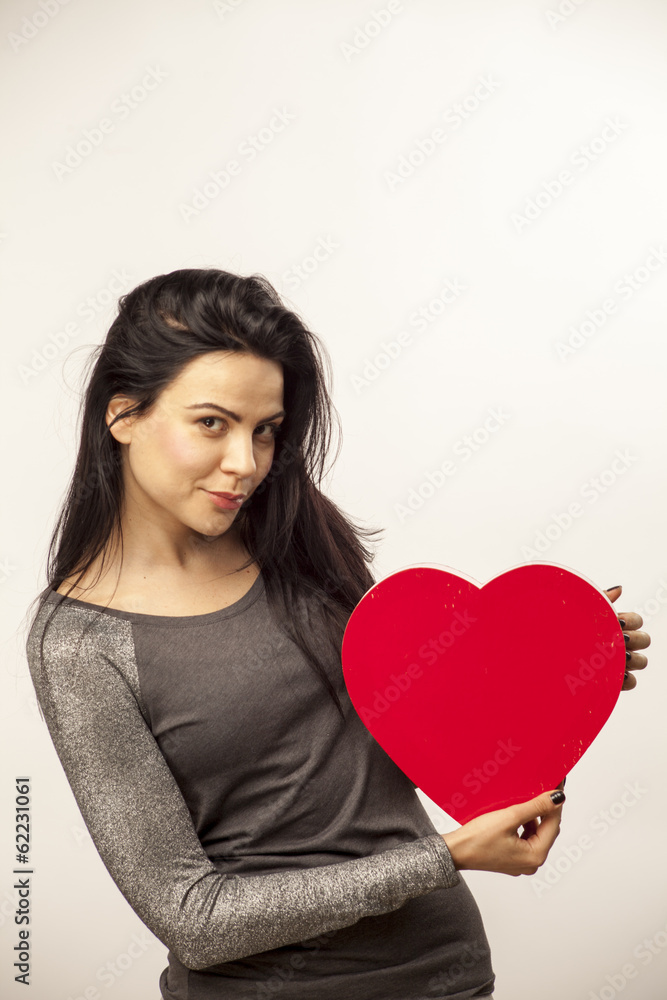 girl holding a heart in her hands girl holding a heart in her hands