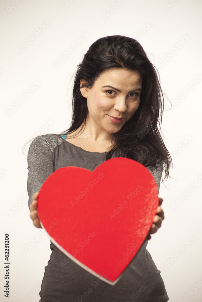 girl holding a heart in her hands girl holding a heart in her hands