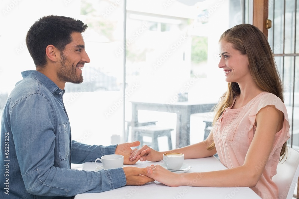 Romantic couple holding hands at coffee shop Romantic couple holding hands at coffee shop