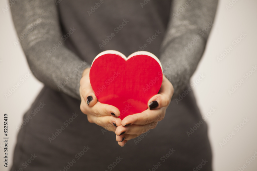 close up of girl holding a heart shaped box