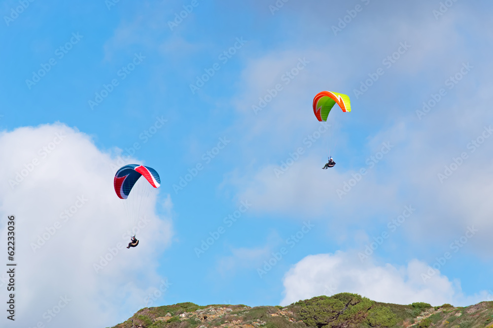 two para gliders on a cloudy day two para gliders on a cloudy day