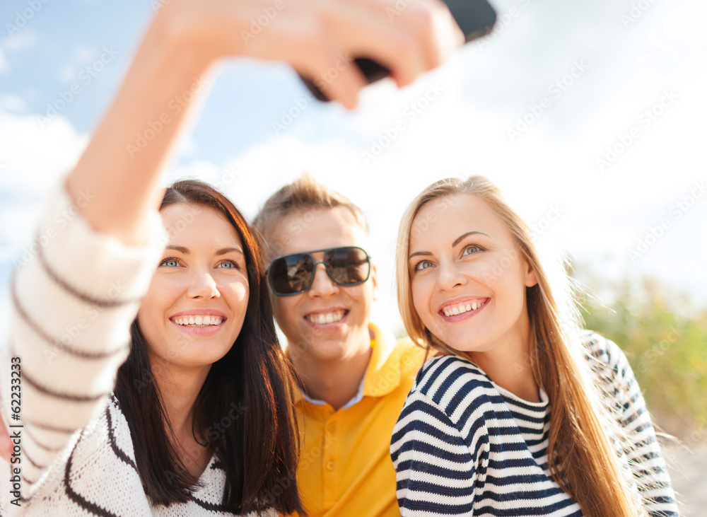 friends taking picture with smartphone camera friends taking picture with smartphone camera