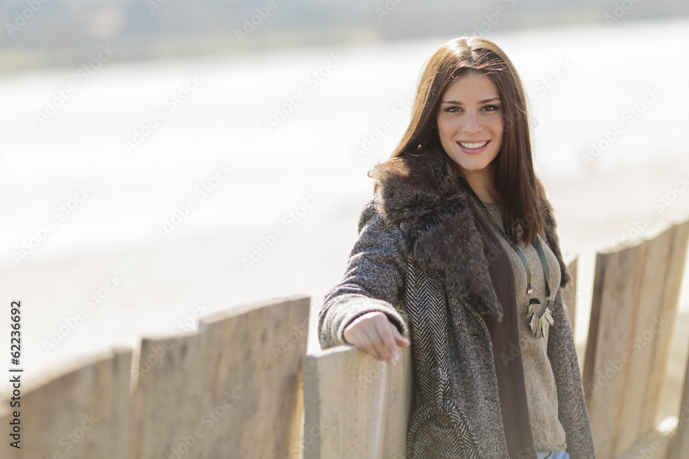 Young woman by the fence