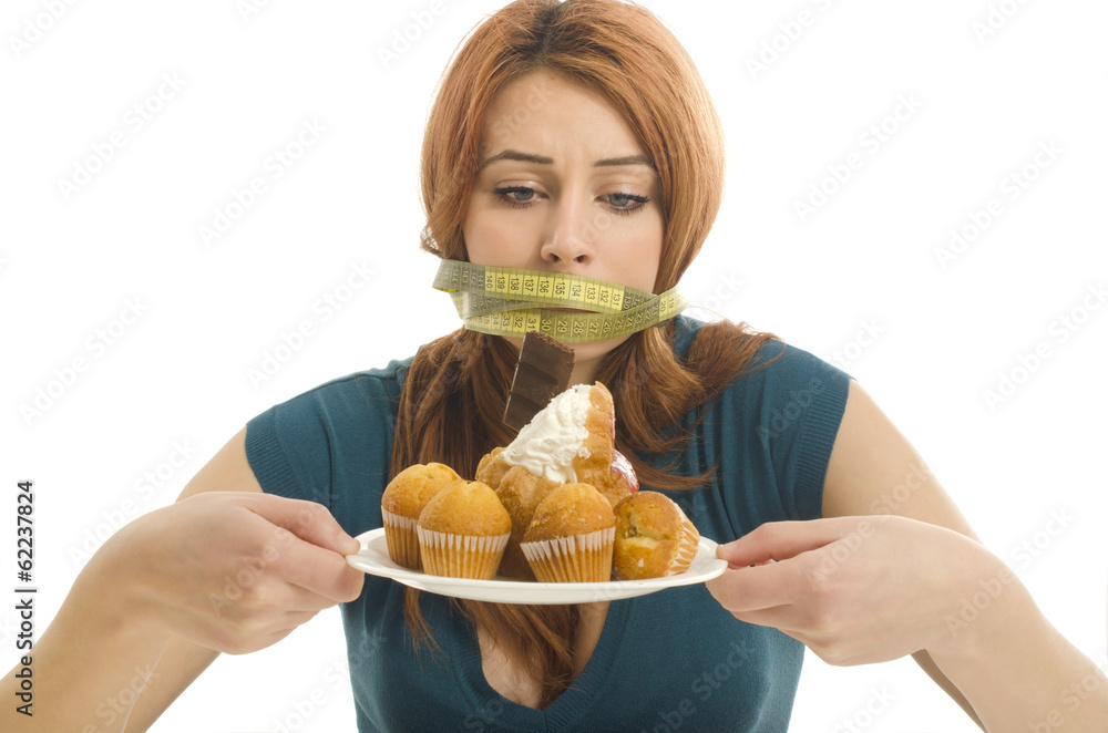 Woman with a centimeter on her mounth unable to eat the sweets Woman with a centimeter on her mounth unable to eat the sweets