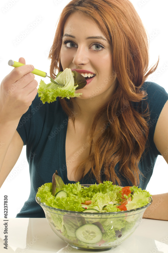 Happy woman eating organic salad. Woman keeping a diet with gree Happy woman eating organic salad. Woman keeping a diet with gree