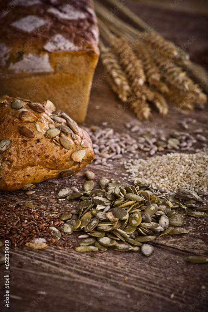 Fototapeta premium fresh bread and wheat on the wooden 