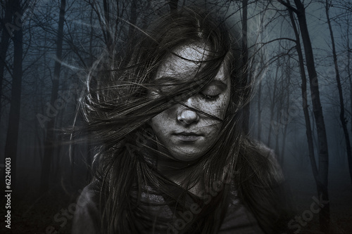 beautiful girl with long hair in dark forest, developing