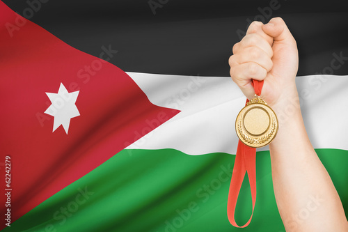 Medal in hand with flag - Hashemite Kingdom of Jordan photo