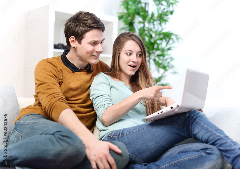 Attractive joyful woman showing something on its laptop computer Attractive joyful woman showing something on its laptop computer