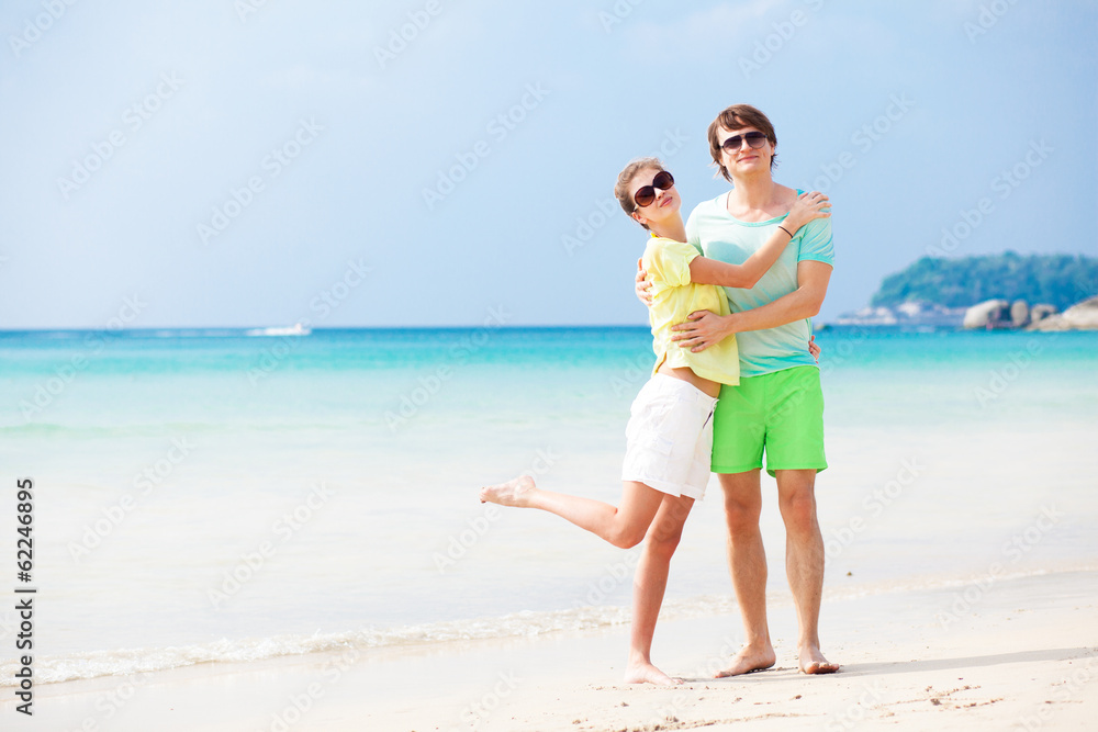 Couple in bright clothes on tropical beach in Thailand Couple in bright clothes on tropical beach in Thailand