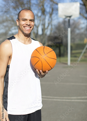 Portrait of a male basketball player on an outdoor court