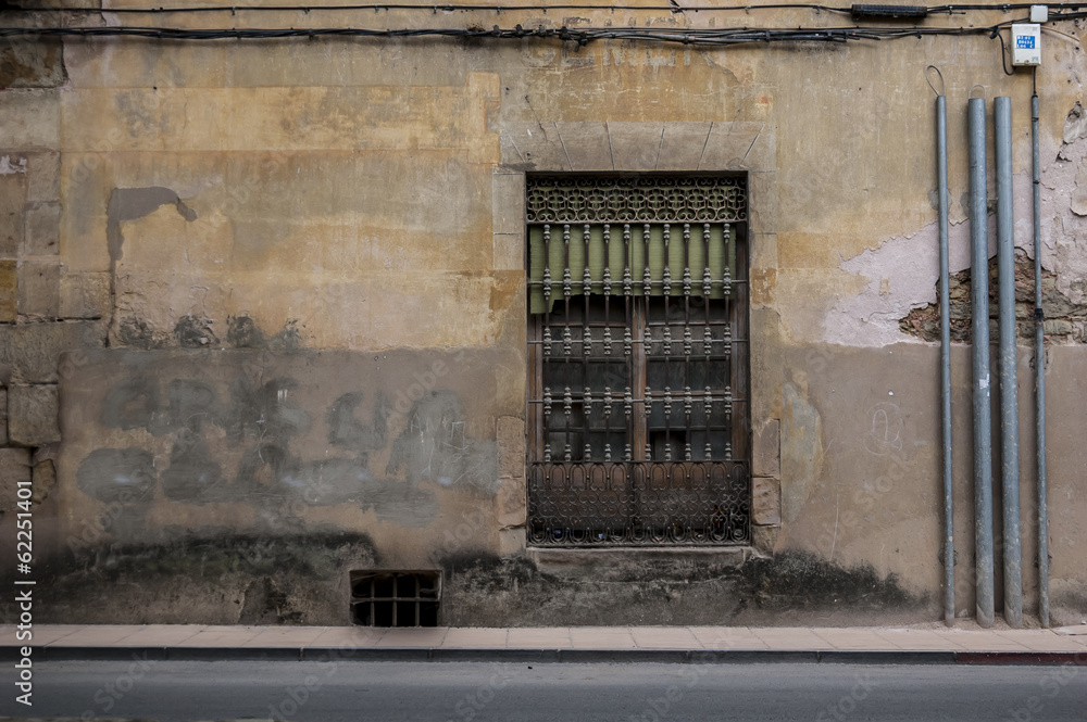 Antique street with rusty window, spanish architecture