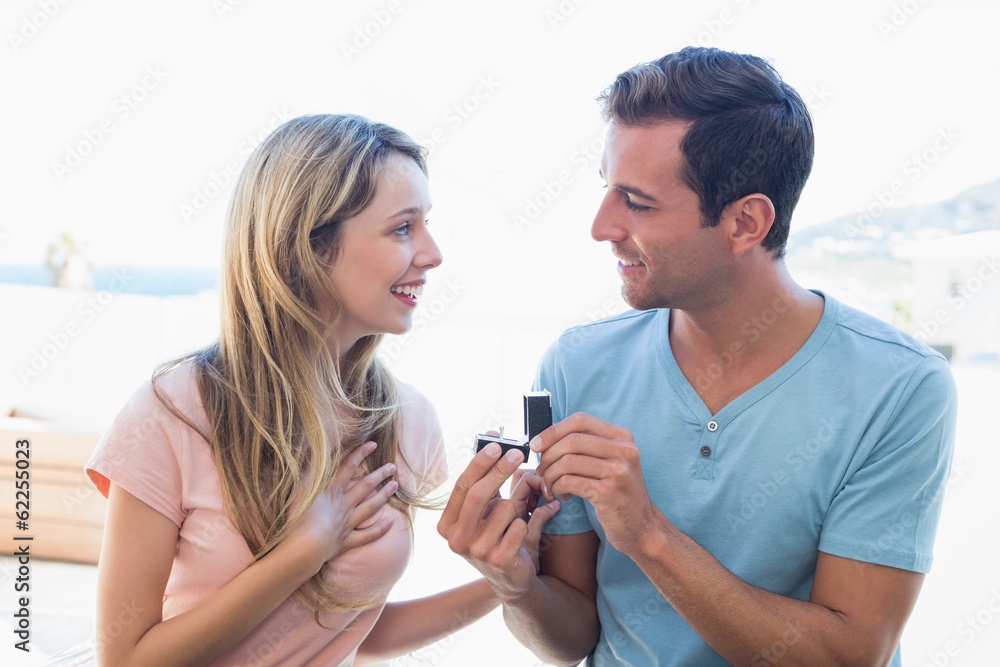 Man surprising beautiful woman with a wedding ring Man surprising beautiful woman with a wedding ring