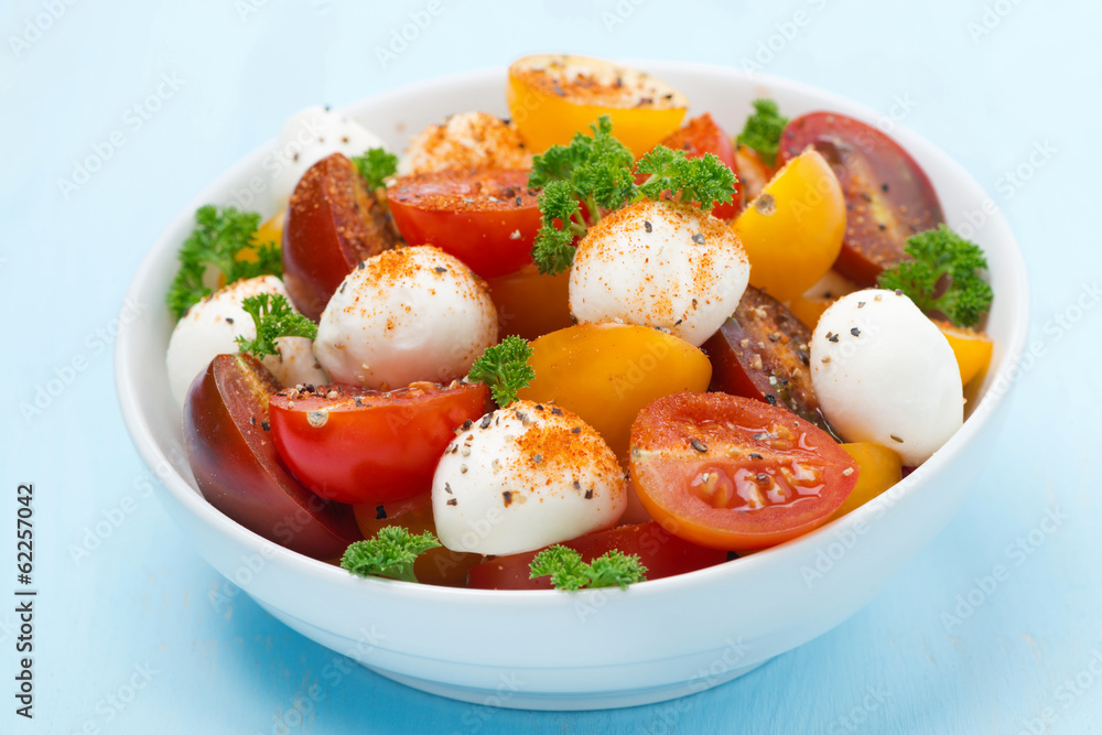 bowl of salad with mozzarella, fresh herbs and cherry tomatoes bowl of salad with mozzarella, fresh herbs and cherry tomatoes