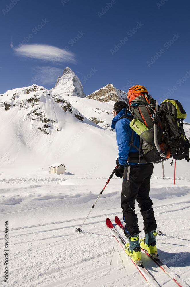 skier looking at snow covered mountains