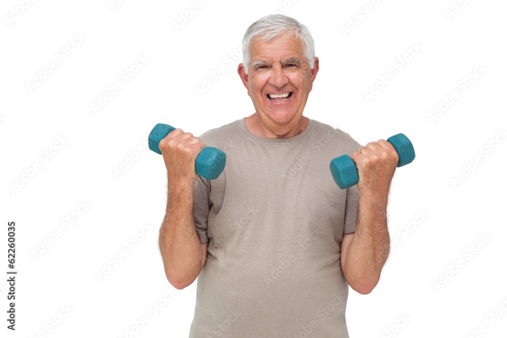 Portrait of a happy senior man exercising with dumbbells Portrait of a happy senior man exercising with dumbbells