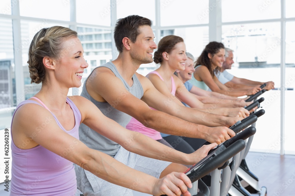 Happy people working out at spinning class Happy people working out at spinning class