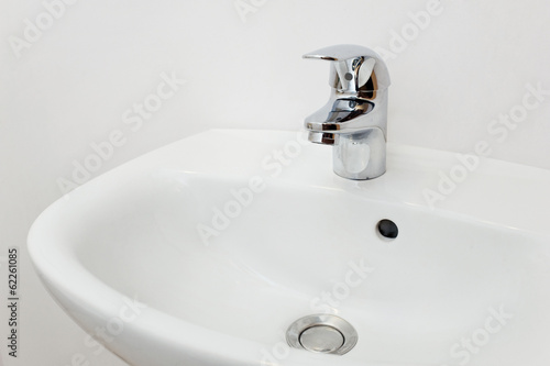 Bathroom interior with white sink and silver faucet