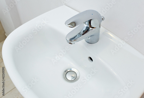 Bathroom interior with white sink and silver faucet