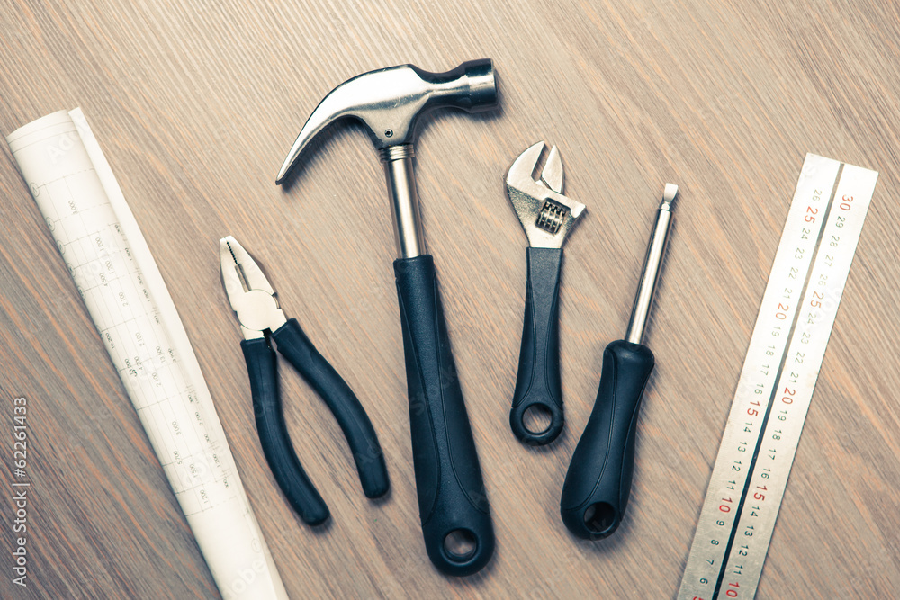 tools against wooden background tools against wooden background