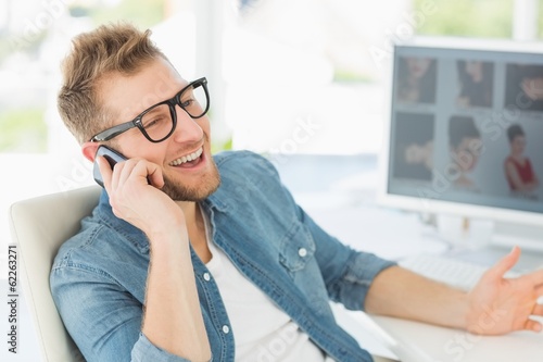 Editor talking on the phone at his desk