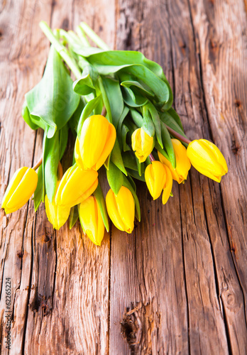 ellow tulips on wood background 