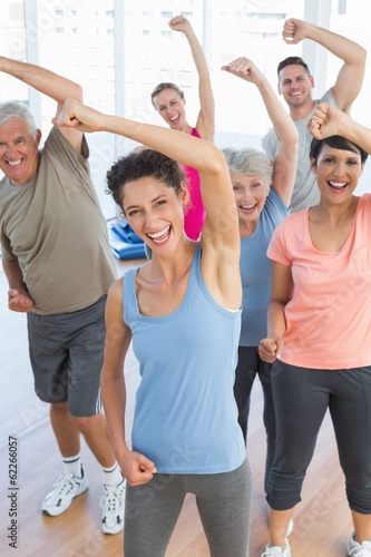 Portrait of smiling people doing power fitness exercise