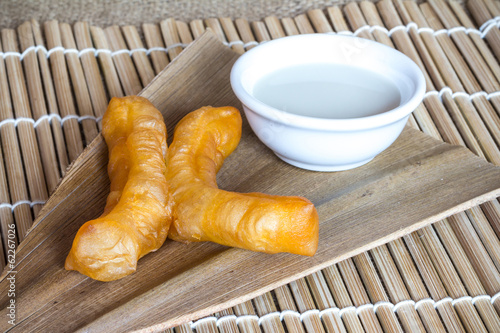 Obraz na płótnie Deep-fried traditional Thai dough stick served with condensed mi
