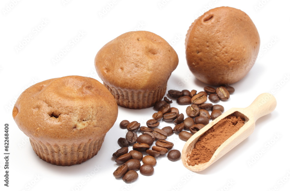 Fresh baked muffins, coffee grains and powdery cinnamon Fresh baked muffins, coffee grains and powdery cinnamon