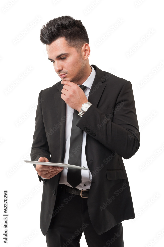 Modern businessman analyzing new information from his ipad Modern businessman analyzing new information from his ipad