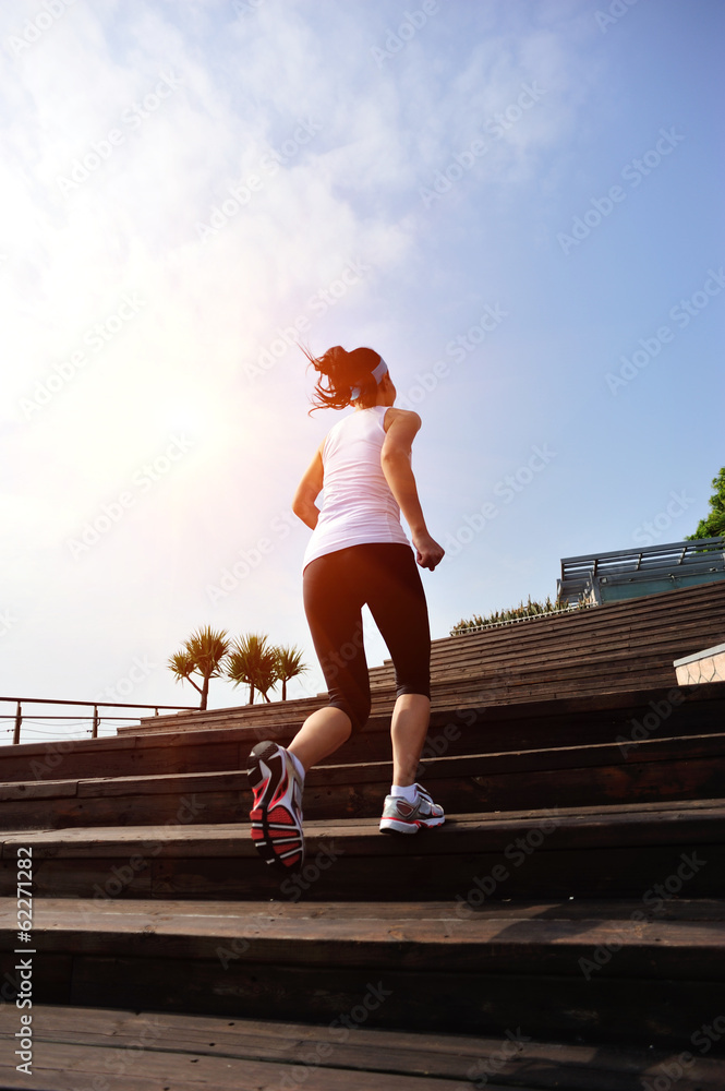 woman running up at wooden stairs