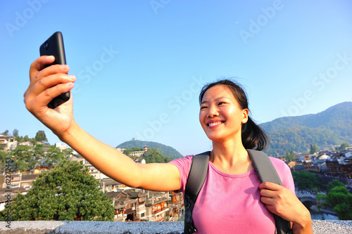woman tourist taking photo with smart phone