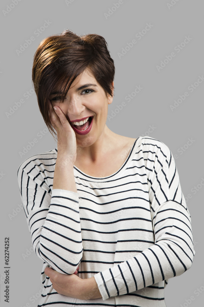 Portrait of a beautiful woman smiling, over a gray background Portrait of a beautiful woman smiling, over a gray background
