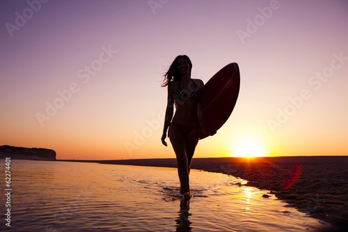 Photography Portrait of a teenage girl in the beach sitting on the sand