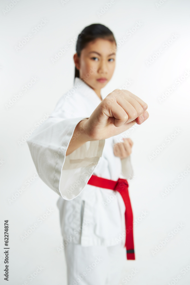 young taekwondo girl in fist fight pose young taekwondo girl in fist fight pose