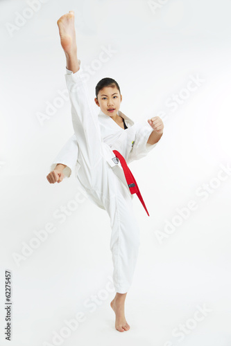 young taekwondo girl kicking