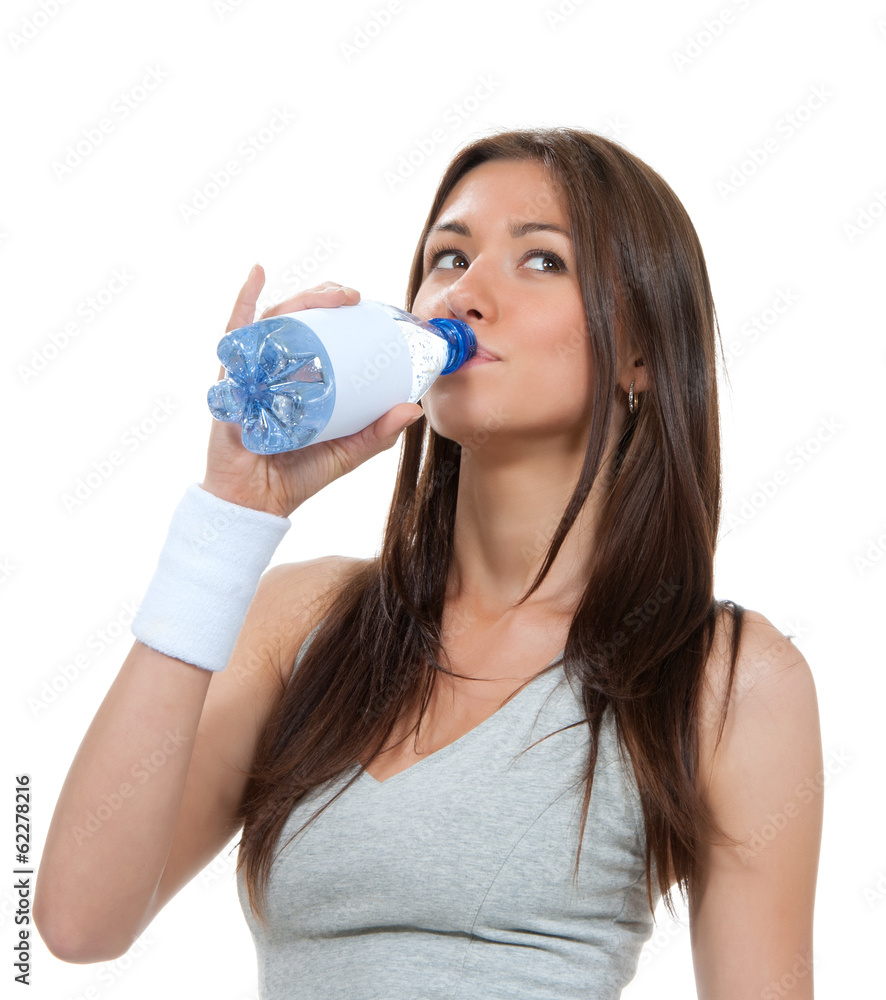 Sporty woman drinking water from clear glass healthy lifestyle w Sporty woman drinking water from clear glass healthy lifestyle w