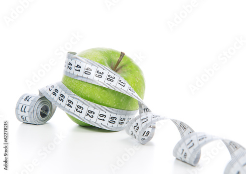 diet weight loss concept green apple and tape measure photo