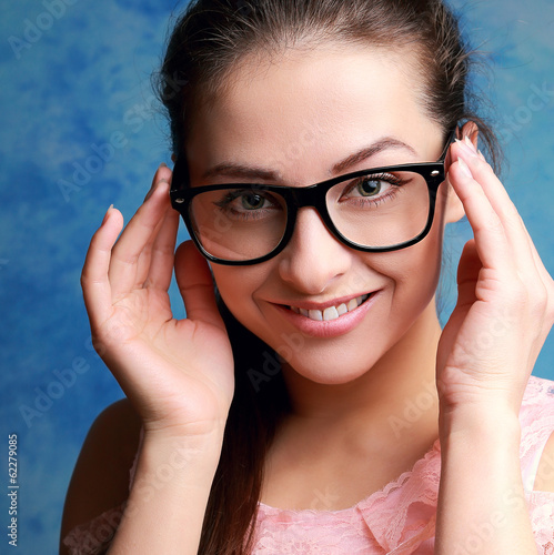 Beautiful woman in glasses looking happy. Closeup portrait