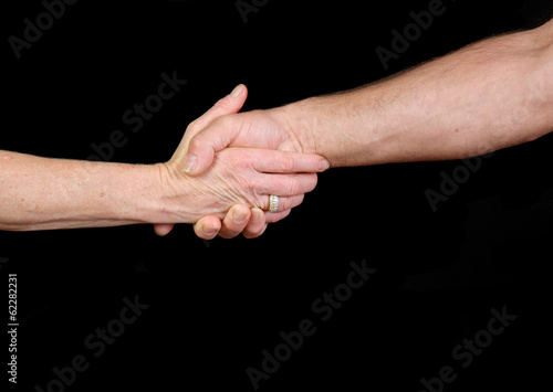 close-up of older couple shaking hands