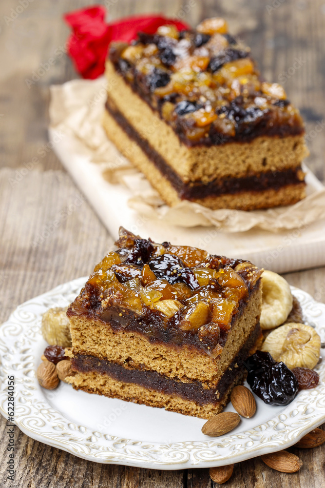 Delicious layer gingerbread cake decorated with dried fruits