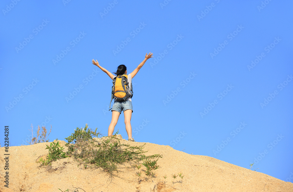 cheering woman hiker open arms at mountain peak cheering woman hiker open arms at mountain peak