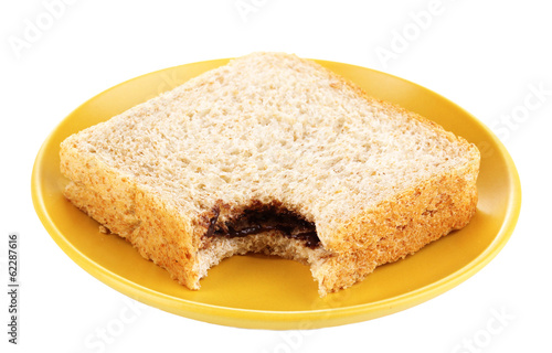 Bitten sandwich with chocolate on plate isolated on white