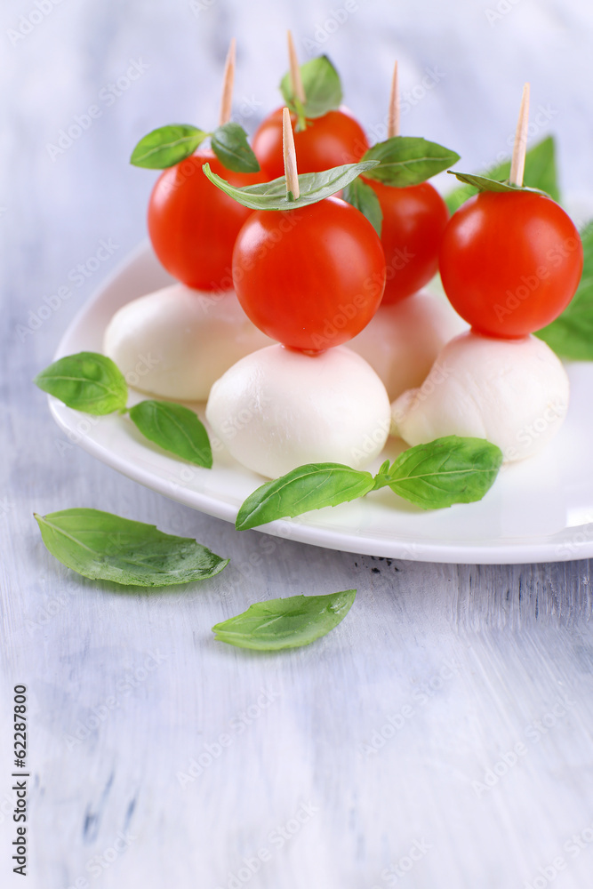 Tasty mozzarella cheese with basil and tomatoes Tasty mozzarella cheese with basil and tomatoes
